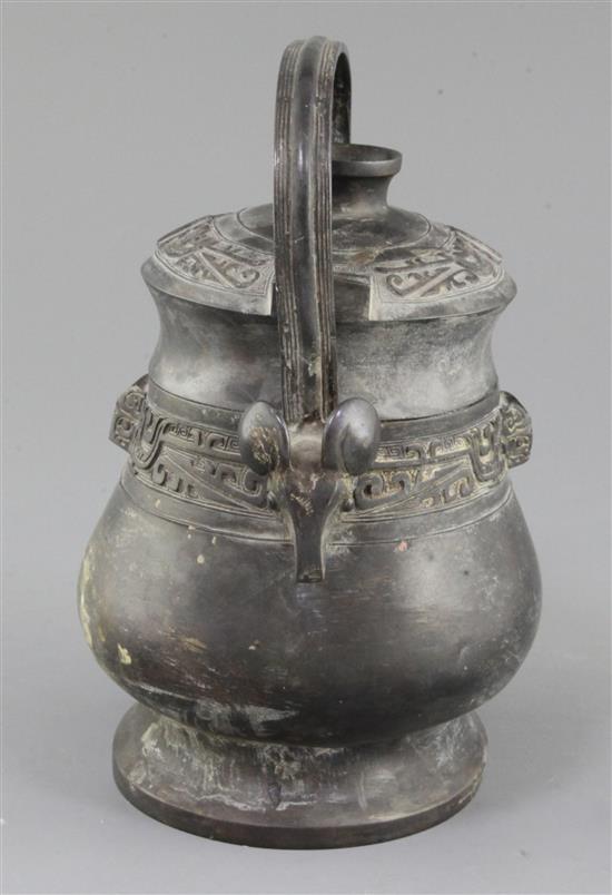 A Chinese archaic bronze ritual wine vessel and cover, You, late Shang/early Western Zhou dynasty, 11th century B.C., 22cm high, repair